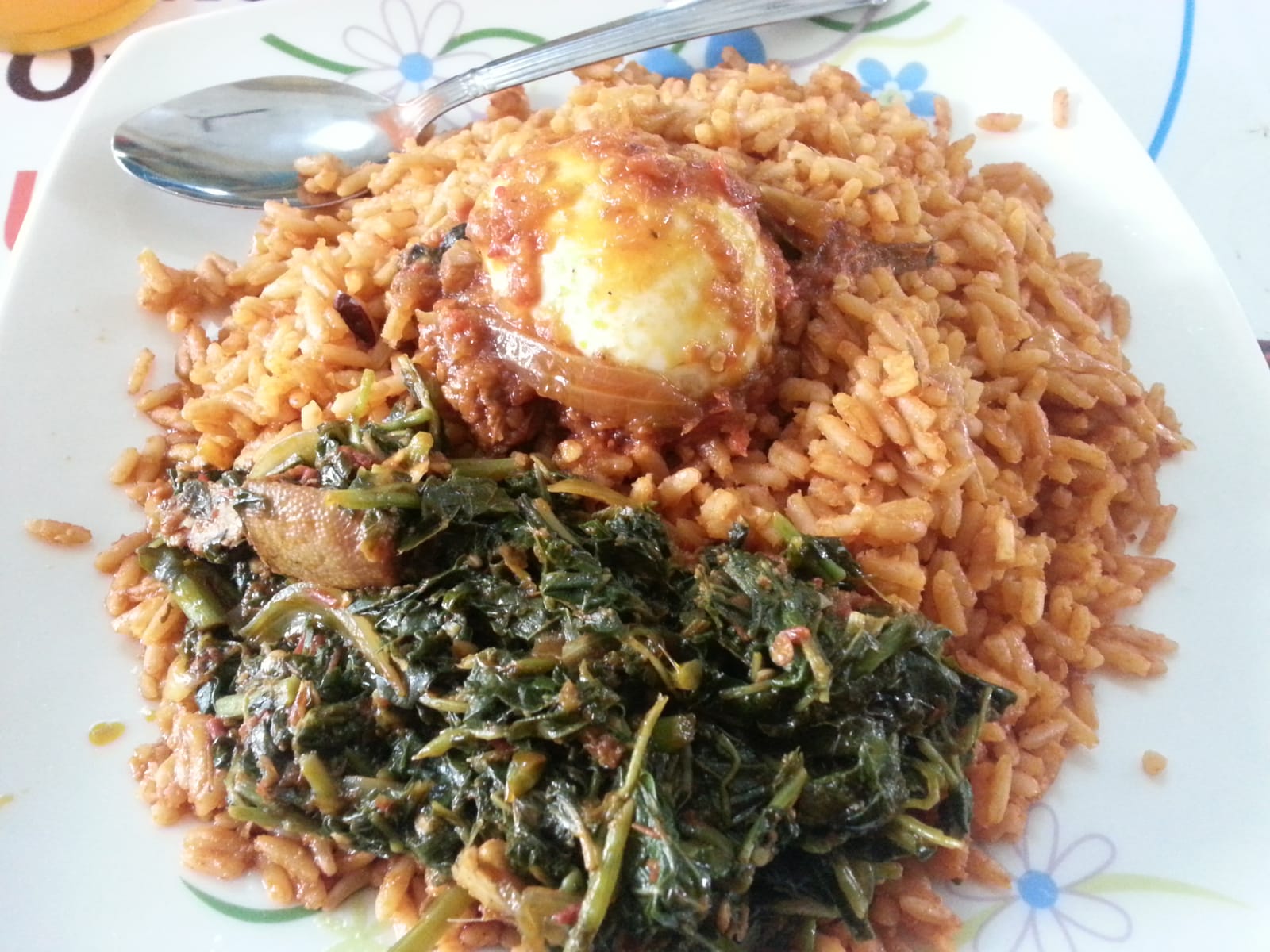 A plate of Gambian benachin rice with fish and vegetables