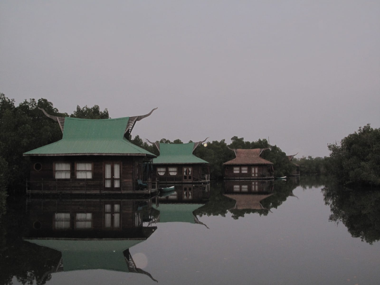 Stilted lodges over a mangrove creek at Makasutu, The Gambia